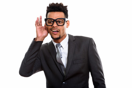 Studio shot of young African businessman listeningの写真素材