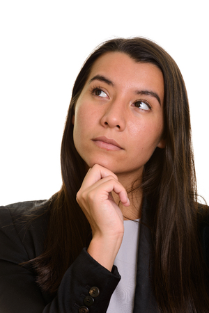 Young Caucasian businesswoman thinking and looking upの写真素材