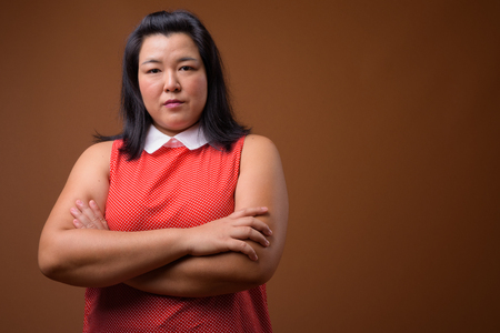 Beautiful overweight Asian woman with arms crossed