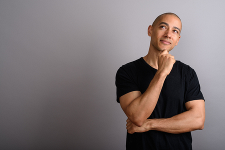 Handsome bald man thinking and looking upの写真素材