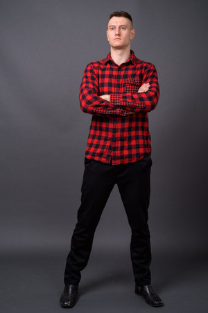 Full body shot of young handsome man with arms crossedの写真素材