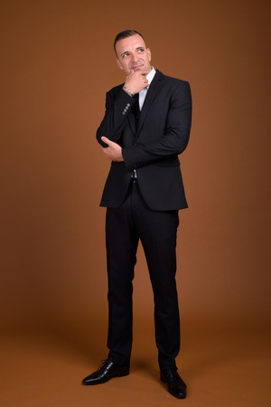 Full length shot of businessman standing and wearing suitの写真素材