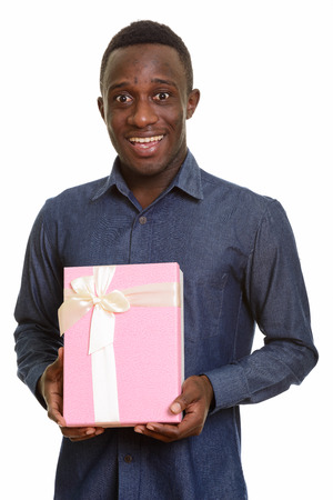 Young happy African man smiling and holding gift boxの写真素材