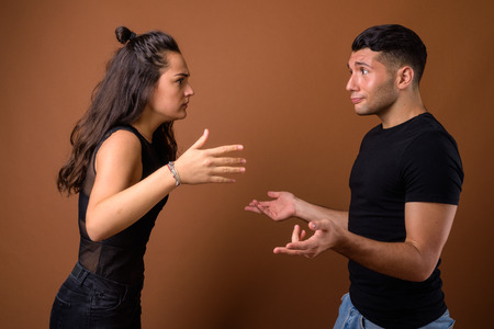 Young couple together and in love against brown backgroundの写真素材