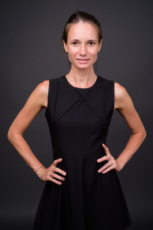 Studio shot of beautiful woman against gray backgroundの写真素材