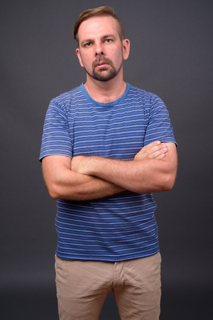 Blond bearded man with goatee against gray backgroundの写真素材