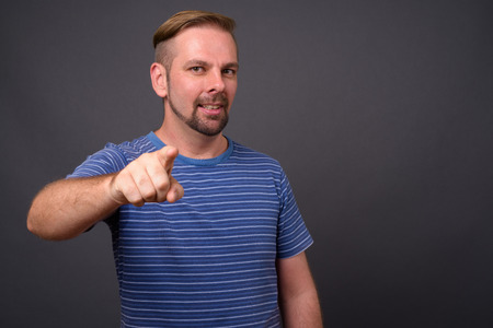 Blond bearded man with goatee against gray backgroundの写真素材