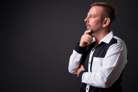 Blond bearded businessman with goatee against gray backgroundの写真素材