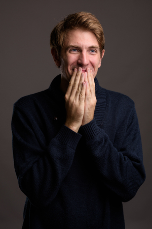 Portrait of handsome man against gray backgroundの写真素材