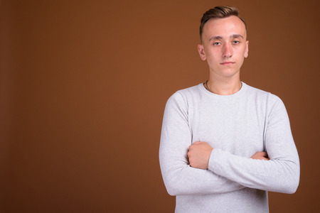 Portrait of young handsome man with arms crossedの写真素材