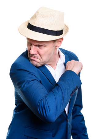 Studio shot of angry mature businessman looking back ready to fiの写真素材