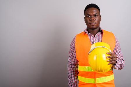 Young African man construction worker against white backgroundの写真素材