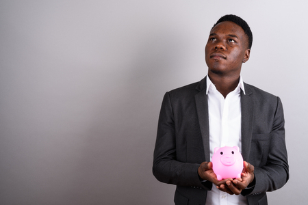 Young African businessman wearing suit against white backgroundの写真素材