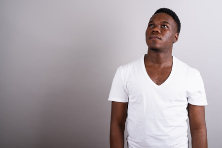 Portrait of young African man against white backgroundの写真素材