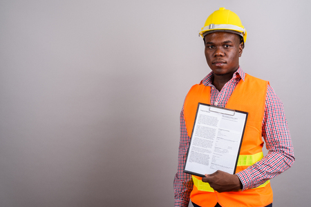 Young African man construction worker against white backgroundの写真素材