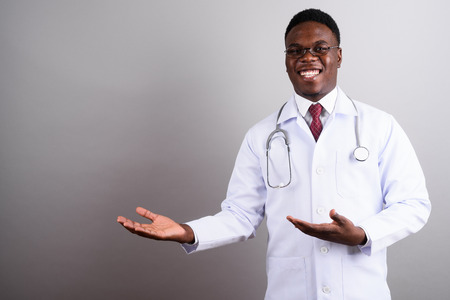 Young African man doctor against white backgroundの写真素材