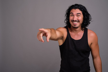 Handsome macho man with mustache against gray backgroundの写真素材