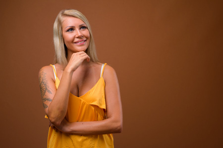 Studio portrait of young beautiful blonde womanの写真素材