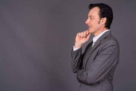 Profile view of mature handsome businessman thinkingの写真素材