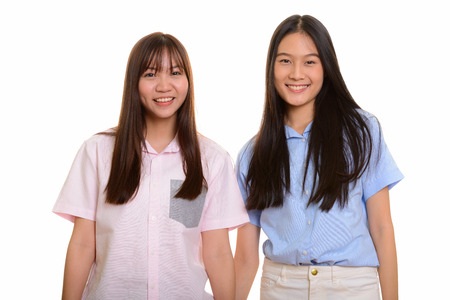 Two young happy Asian teenage girls smilingの写真素材