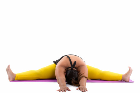 Studio shot of young happy fat Asian woman smiling and splittingの写真素材
