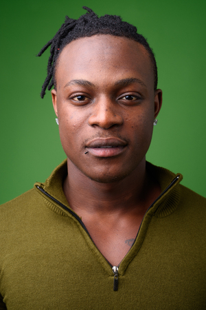 Young handsome African man from Kenya against green backgroundの写真素材
