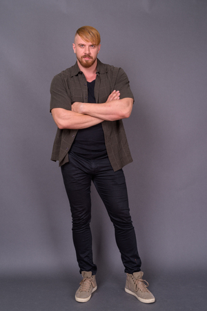 Bearded man with blond hair against gray backgroundの写真素材