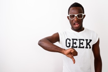 Studio shot of sad young black African nerd man giving thumb dowの写真素材