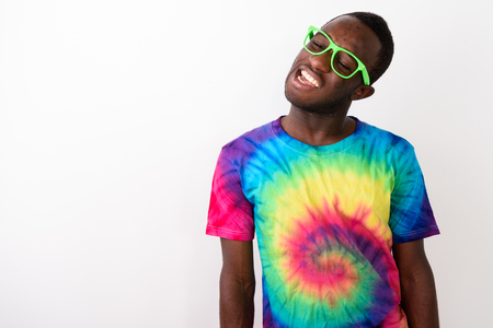 Studio shot of young black African man having neck pain againstの写真素材