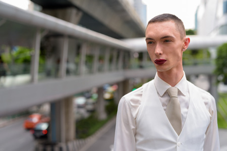 Young androgynous homosexual LGTB businessman wearing lipstickの写真素材