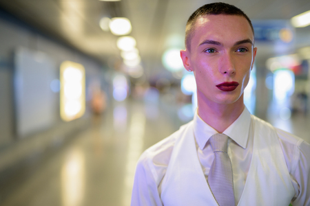 Young androgynous homosexual LGTB businessman wearing lipstickの写真素材