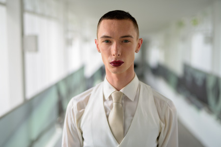 Young androgynous homosexual LGTB businessman wearing lipstickの写真素材