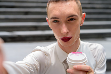 Personal point of view of young androgynous homosexual LGTB man taking selfieの写真素材