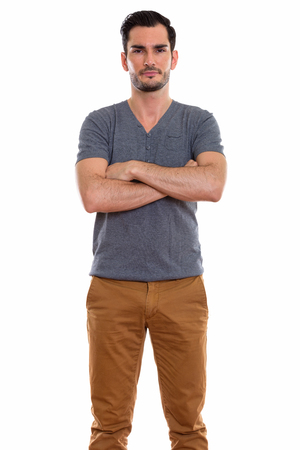Studio shot of young handsome man standing with arms crossedの写真素材