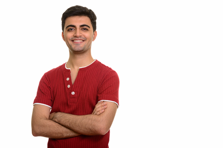 Young happy Persian man smiling and looking at cameraの写真素材