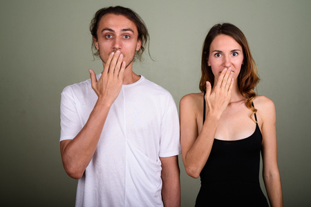 Young handsome man and young beautiful woman together against coの写真素材