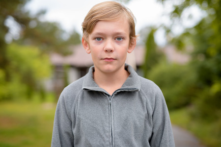 Young Handsome Boy With Blond Hair At Home Outdoorsの写真素材