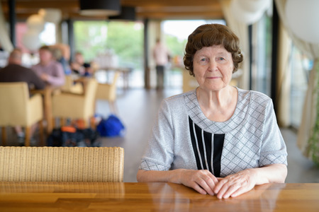 Beautiful Senior Woman Sitting At The Coffee Shopの写真素材