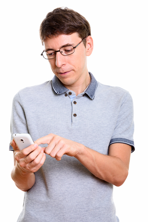 Studio shot of man using mobile phoneの写真素材