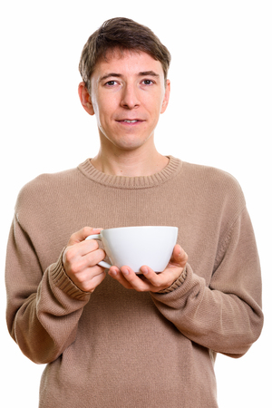 Studio shot of man holding coffee cupの写真素材