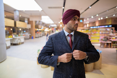 Portrait of Indian businessman with turban in shopping mallの写真素材