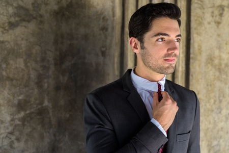Portrait of young handsome businessman wearing suit in cityの写真素材