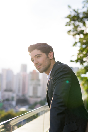 Portrait of young handsome businessman wearing suit in cityの写真素材
