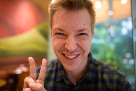 Young happy tourist man personal point of view selfieの写真素材