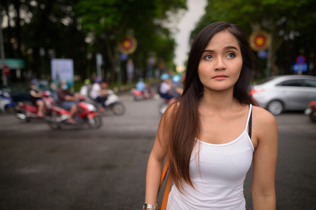 Young beautiful Asian tourist woman exploring Ho Chi Minh city iの写真素材