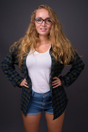 Portrait of young beautiful woman with long wavy blond hairの写真素材