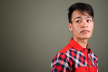 Young handsome Indian man against colored backgroundの写真素材