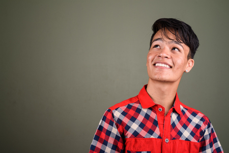 Young handsome Indian man against colored backgroundの写真素材