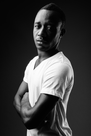 Young African man against black background in black and whiteの写真素材