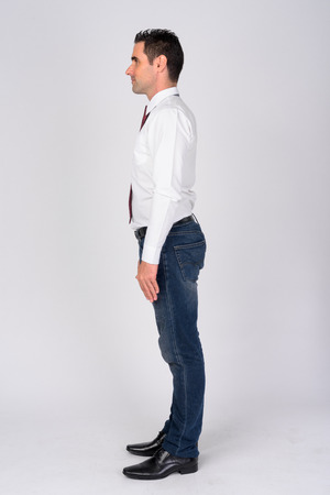 Full body shot profile view of handsome businessman against whiteの写真素材
